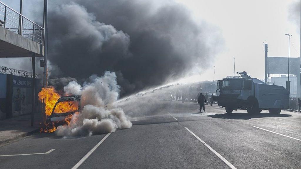 South Africa erupts: 24 cars burned, shops looted as anti‑immigration protests turn violent
