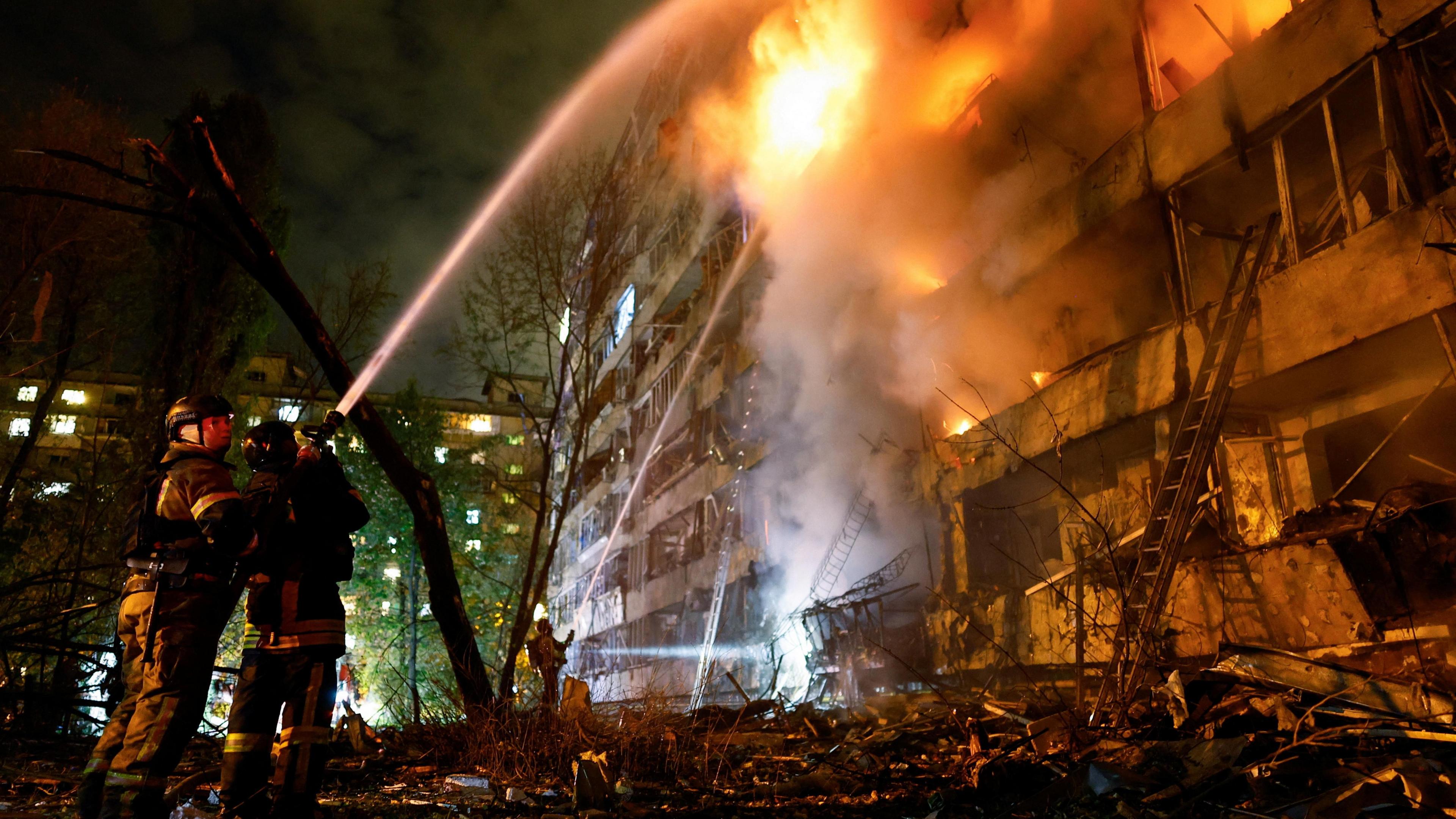 Firefighters on the scene of a missile strike