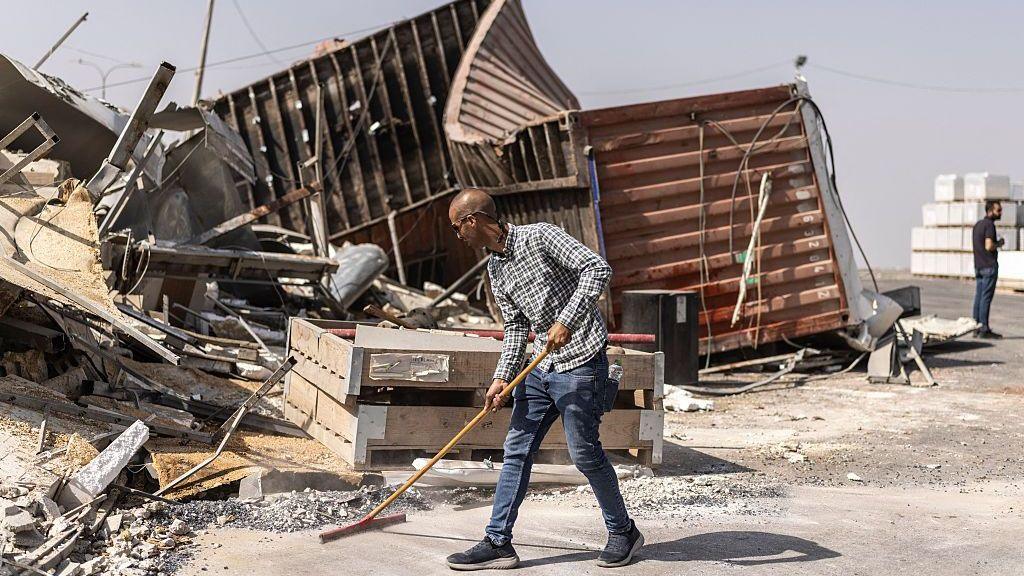 Bulldozers sweeping debris in Hebron