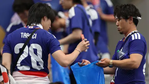Japanese football fans praised for stadium clean‑ups but pulled for leaving household chores to wives