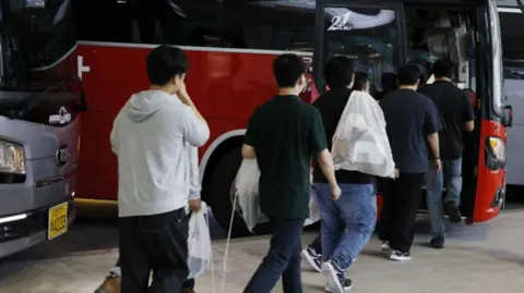 South Korean Workers' Ordeal: Detained Under Armored Forces in US Immigration Raid