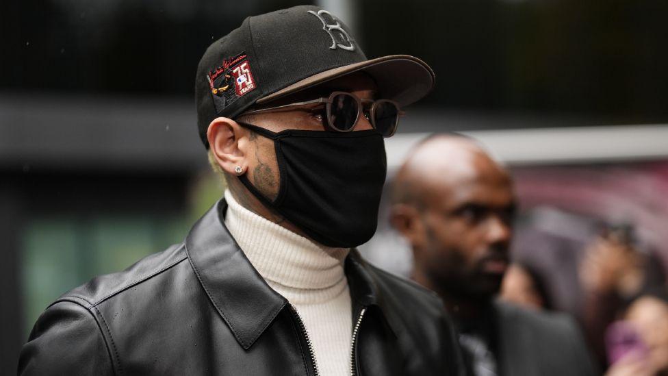 Chris Brown arriving at Southwark Crown Court wearing a mask and sunglasses