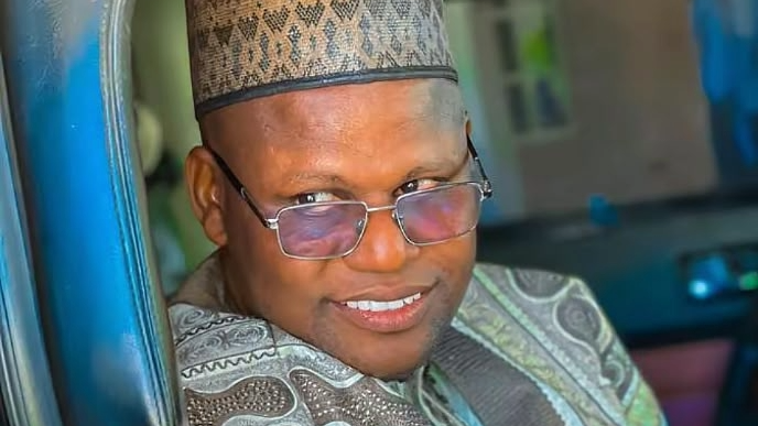 Yahaya Masussuka, a Nigerian Islamic cleric, smiling while in a car.